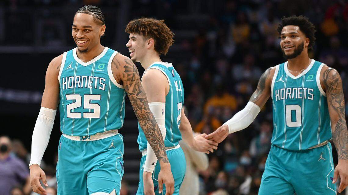 Charlotte Hornets forward PJ Washington, left, guard LaMelo Ball, center and forward Miles Bridges, right, enjoy their play against the Los Angeles Lakers during first half action at Spectrum Center in Charlotte, NC on Friday, January 28, 2022.