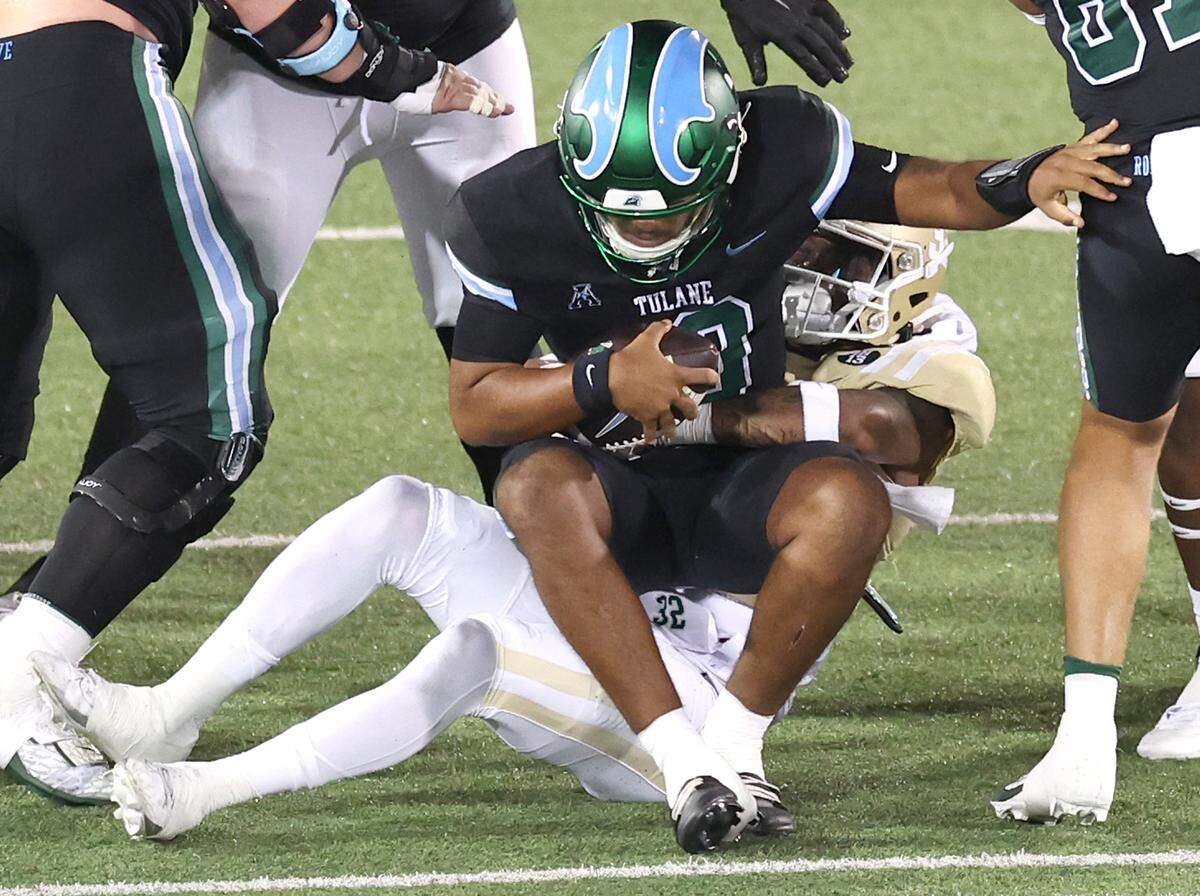 Charlotte 49ers defensive back Mordecai McDaniel, right/center, sacks Tulane quarterback Darian Mensah, left/center, during action on Thursday, October 31, 2024 at Jerry Richardson Stadium in Charlotte, NC.