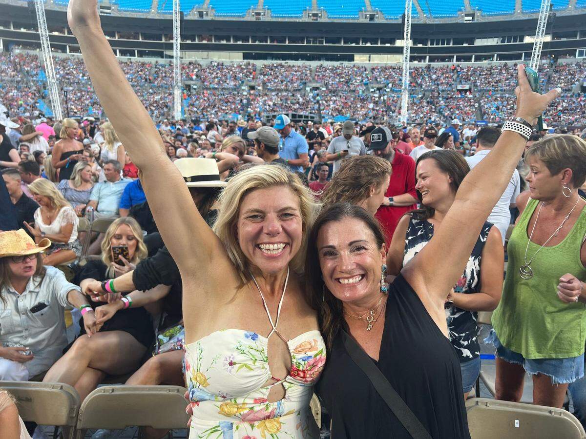 Molly Grantham and a friend celebrate their ticket upgrade at Garth Brooks’ show in Charlotte.