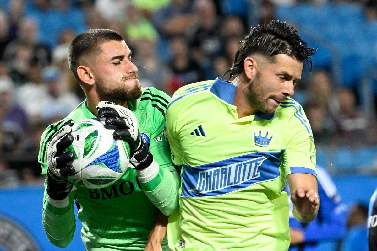 Sep 27, 2025; Charlotte, North Carolina, USA; CF Montréal goalkeeper Thomas Gillier (31) makes a save as Charlotte FC midfielder Brandt Bronico (13) pressures in the first half at Bank of America Stadium. Mandatory Credit: Bob Donnan-Imagn Images