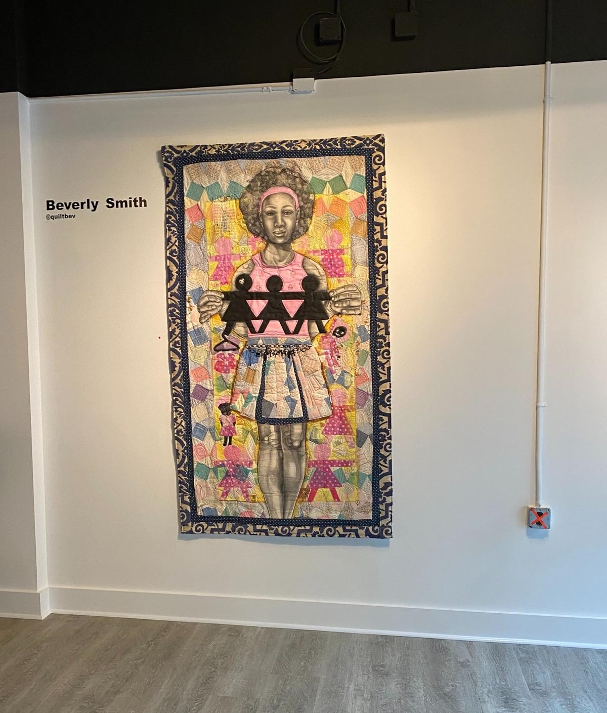 Artwork by Beverly Smith, who is a mixed-media fiber artist and quilter, and a former teacher at West Charlotte High School. She uses a collage-like style, reflecting themes from the Antebellum South.