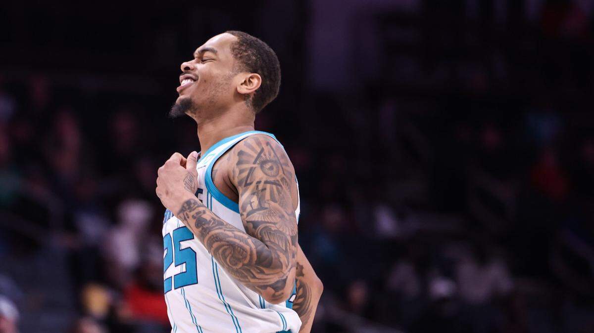 Charlotte Hornets forward P.J. Washington (25) smiles as he runs up the court against the Atlanta Hawks at the Spectrum Center in Charlotte, N.C., on Monday, February 13, 2023.