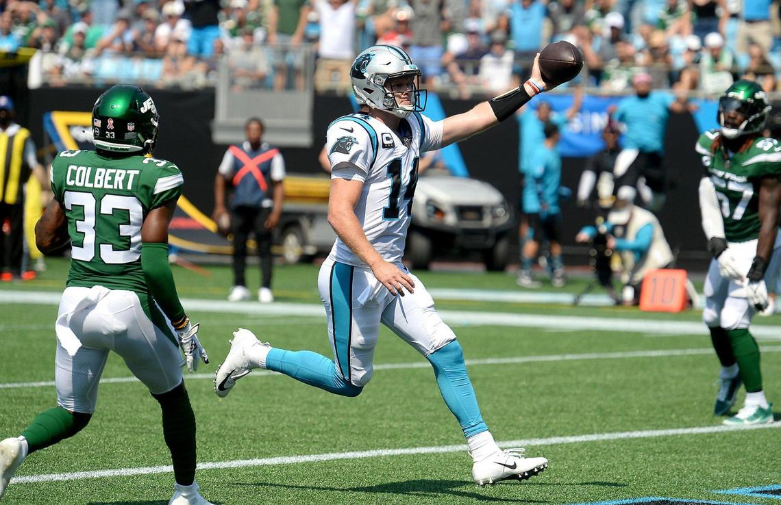 Carolina Panthers quarterback Sam Darnold rushes for a touchdown during second-quarter action on a quarterback draw.