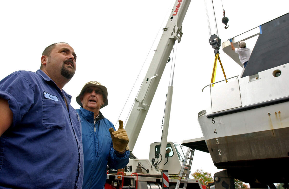 Marshall Crouch speaks with Jerry “Bear” Fogel, of LaCrosse, Wisconsin, about adding the second level onto the 90-foot long Lady of the Lake yacht on Lake Norman in 2005.