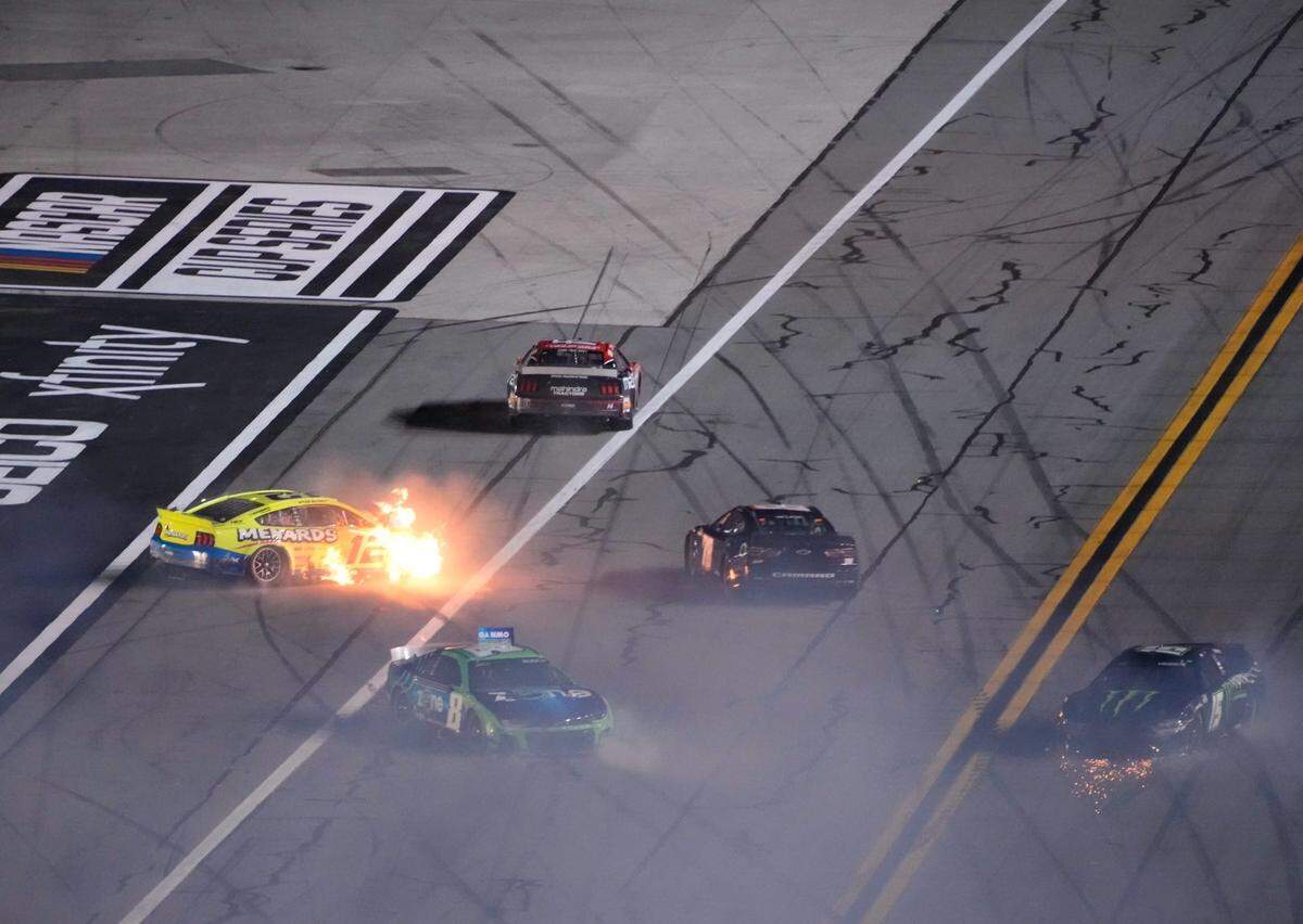 Ryan Blaney’s car (12) bursts into flames as a massive crash late in the second Daytona Duel brings out the red flag.