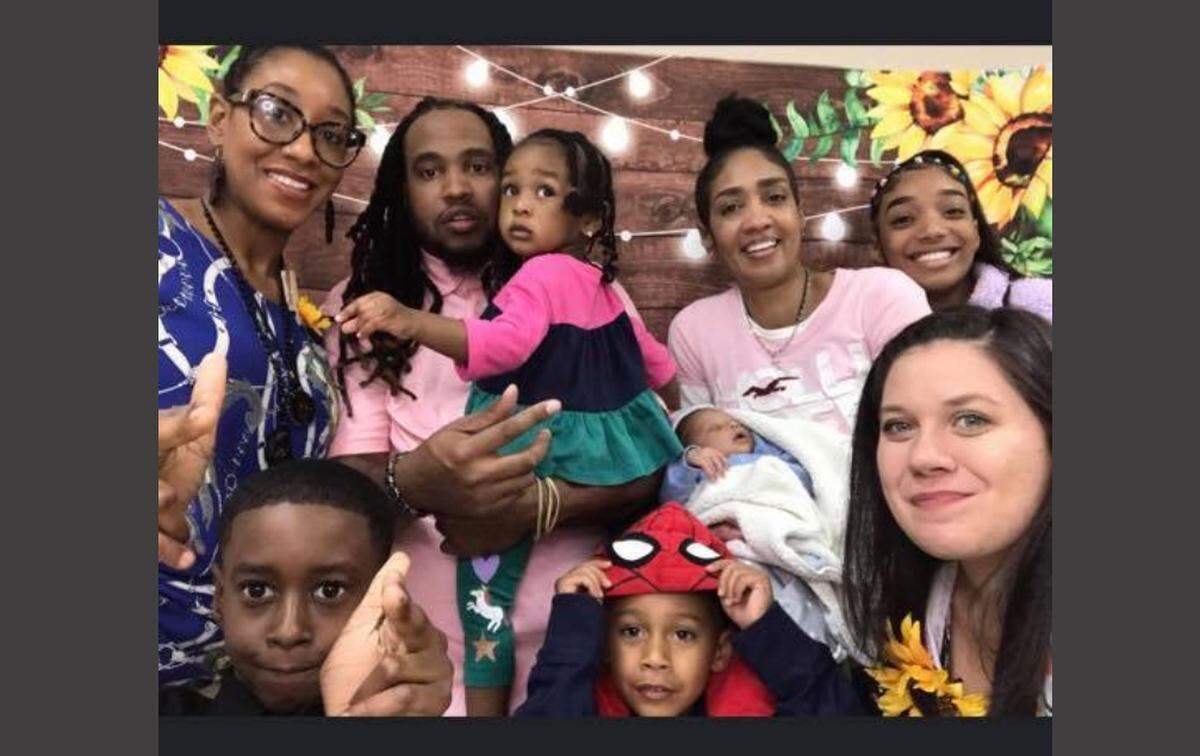 Kimberlie Flemings, at right in pink shirt, celebrates an October baby shower for her approaching granddaughter with her family in Mount Holly.