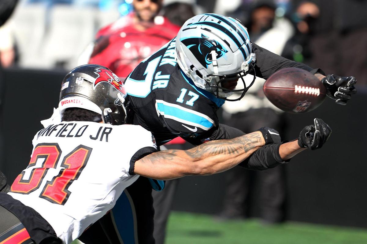 Carolina Panthers wide receiver DJ Chark, right, fumbles the football at the goal line as he is hit by Tampa Bay Buccaneers safety Antoine Winfield Jr., left, during second-quarter action at Bank of America Stadium in Charlotte, NC on Sunday, January 7, 2024.