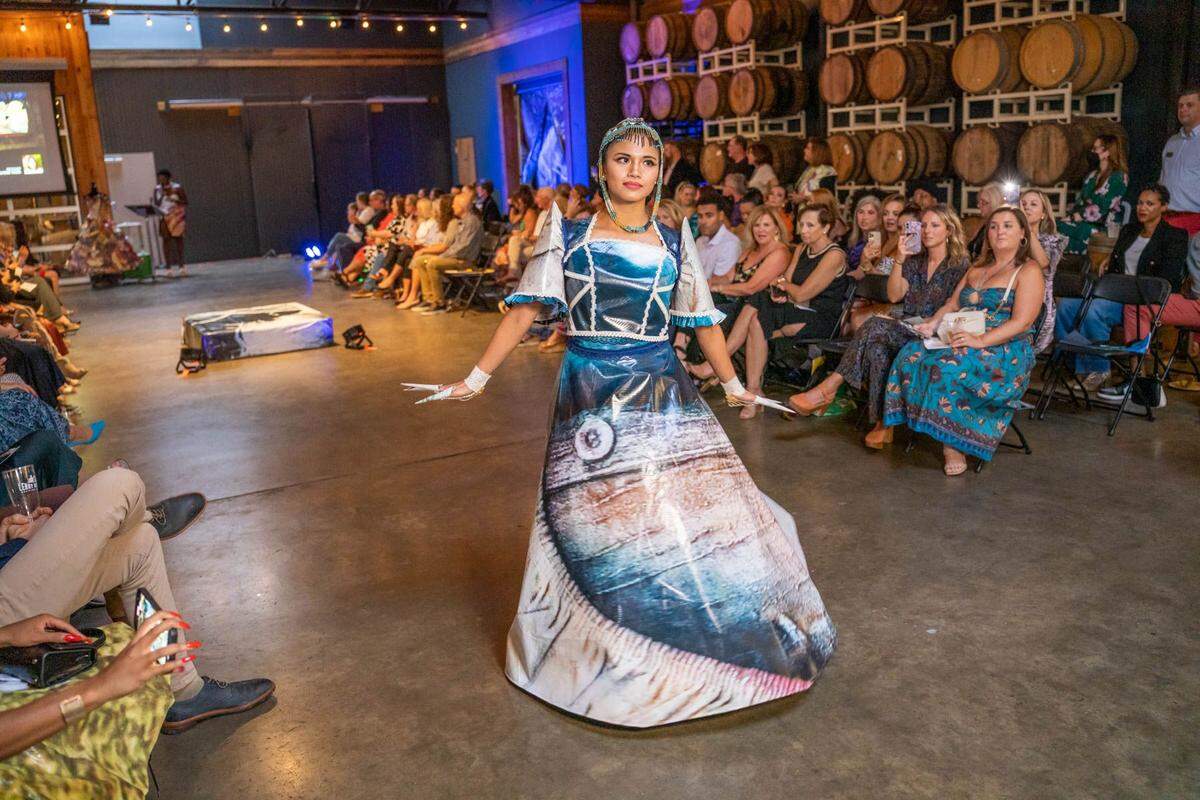 Edelweiss Vogel created this 2022 Upcycled Fashion Dress. It’s made from billboard art created by Caroline Rust. The model is Vogel's sister, &nbsp;Eilleen De Guzman, who also will model Vogel's design at this year's show.