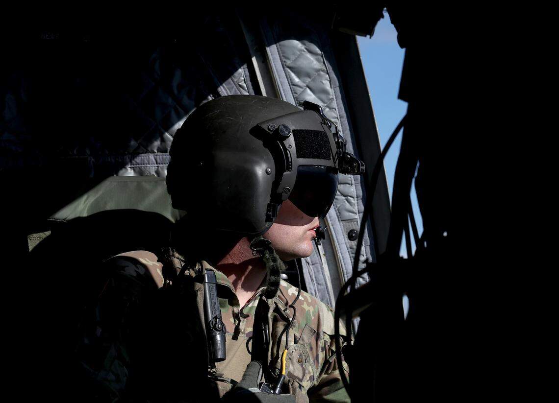 Bravo Company 1-171 crew member Ryan Venden watches for other air traffic as the team flies a mission to Western North Carolina to deliver bottled water and ready to eat meals on Thursday, Oct. 3, 2024.