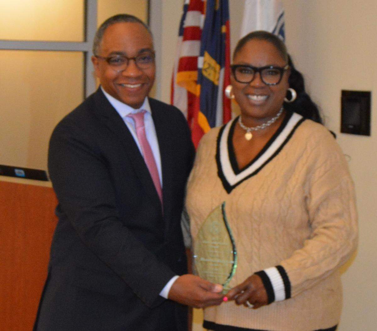 Mecklenburg District Attorney Spencer Merriweather awards Rhamonda Blackmon with The Above and Beyond Citizen Award.
