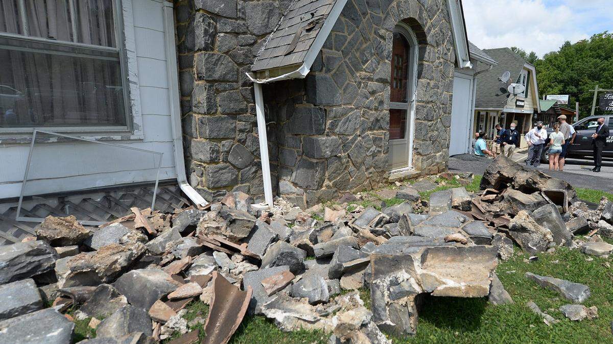 Cut stone from a chimney and siding of a home in Sparta, NC rests in the front yard as North Carolina Governor Roy Cooper, right, looks at damage on Tuesday, 11, 2020. The city of Sparta sustained a 5.1 magnitude earthquake on Sunday, August 9, 2020. Residents of south Charlotte reported a tremor on Wednesday, Nov. 18, 2020.