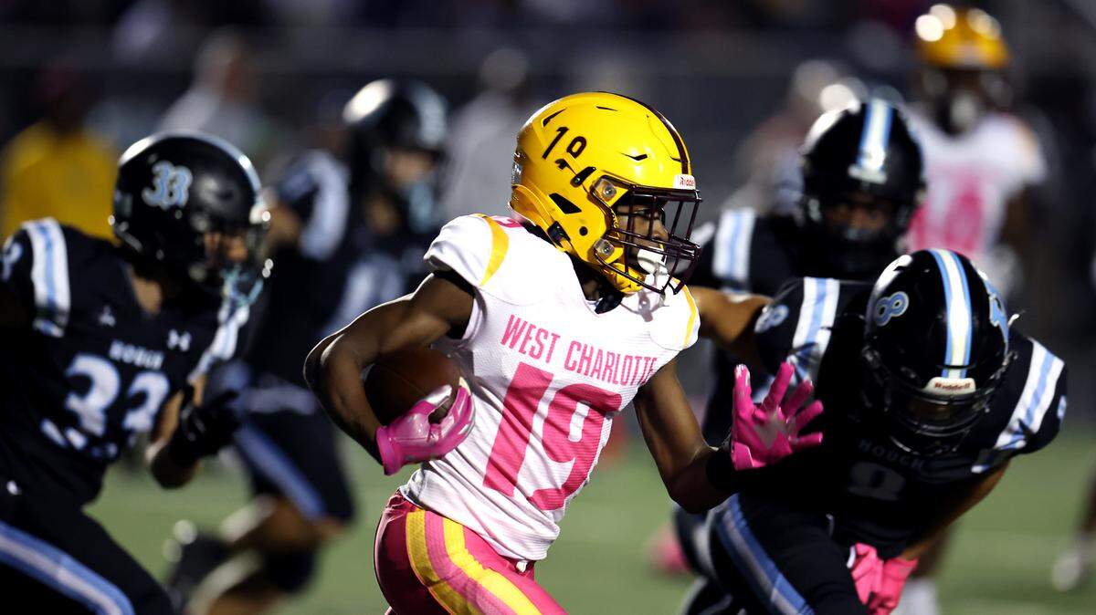 West Charlotte wide receiver Donte Nicholson, center, breaks to the outside following a pass reception against the Hough Huskies during action on Friday, October 6, 2023.