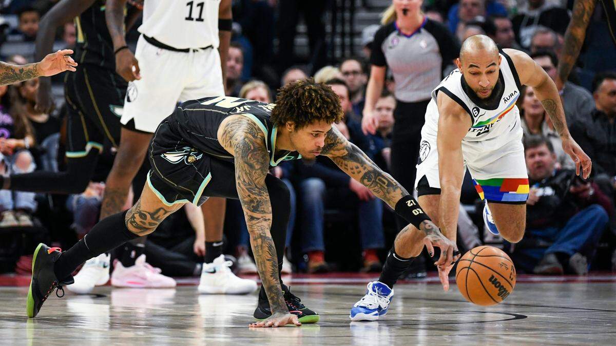 Minnesota Timberwolves guard Jordan McLaughlin, right, steals the ball from Charlotte Hornets guard Kelly Oubre Jr. during the first half of an NBA basketball game Friday, Feb. 24, 2023, in Minneapolis. (AP Photo/Craig Lassig)