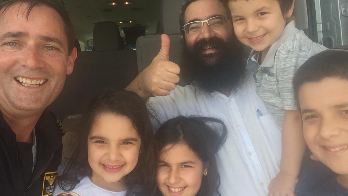 Rabbi Moshe Leiblich of Chabad of Wilmington gives the thumbs up after a helicopter delivered 150 pounds of kosher food to the hurricane-ravaged coastal city. From left to right: Mark Fisher, the pilot; and Leiblich’s children Yehudis, Chayale, Berel and Isser. The kosher food was prepared, packaged and sent by Charlotte’s Ohr HaTorah, an Orthodox Jewish community.