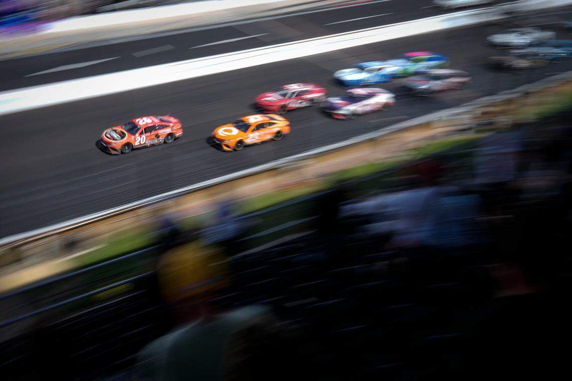 Christopher Bell (20) leads the field on a restart for the final segment during the running of a NASCAR cup series auto race at Indianapolis Motor Speedway, Sunday, July 31, 2022, in Indianapolis. (AP Photo/AJ Mast)
