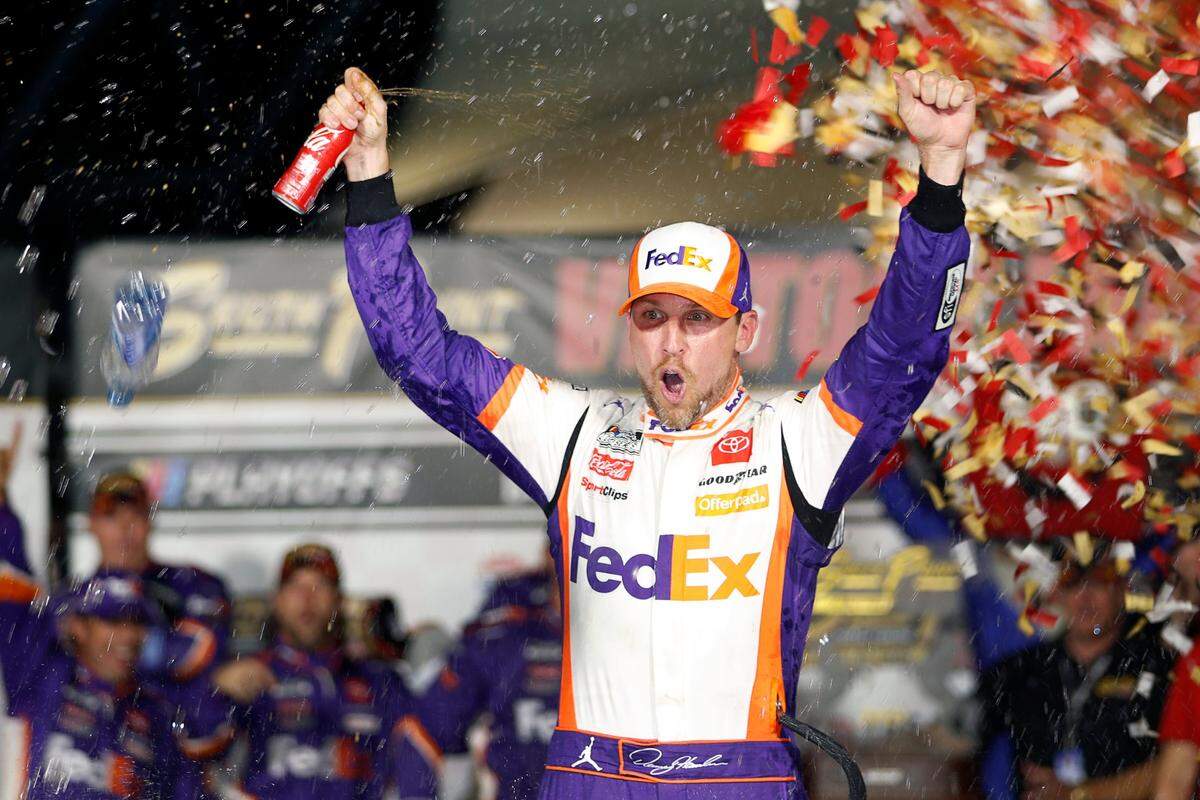 NASCAR Cup Series driver Denny Hamlin (11) celebrates in victory lane after winning a NASCAR Cup Series auto race at the Las Vegas Motor Speedway Sunday, Sept. 26, 2021, in Las Vegas. (AP Photo/Steve Marcus)