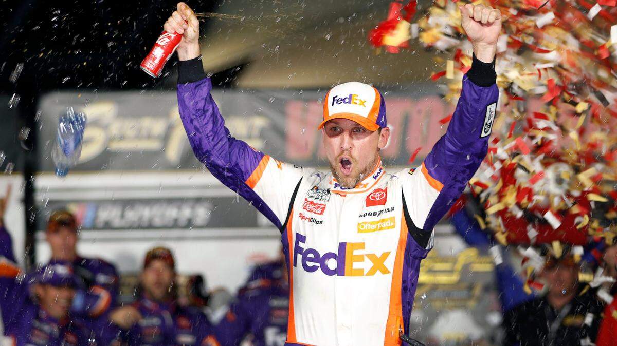 NASCAR Cup Series driver Denny Hamlin (11) celebrates in victory lane after winning a NASCAR Cup Series auto race at the Las Vegas Motor Speedway Sunday, Sept. 26, 2021, in Las Vegas. (AP Photo/Steve Marcus)