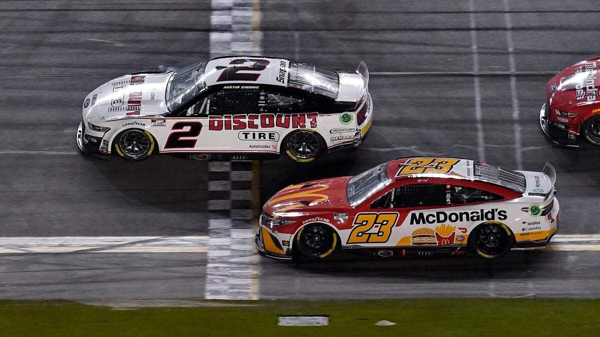 Austin Cindric (2) edges out Bubba Wallace (23) to win the NASCAR Daytona 500 auto race Sunday, Feb. 20, 2022, at Daytona International Speedway in Daytona Beach, Fla. (AP Photo/Chris O’Meara)
