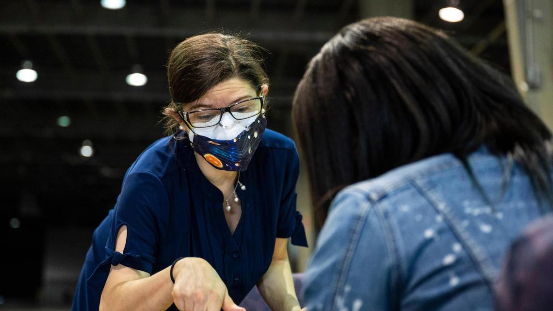 Lissa Hawksley, left, helps a woman apply for rent payment assistance at the Park Expo on Oct. 1, 2021 in Charlotte. After the Supreme Court knocked down the federal eviction moratorium, renters have fewer protections during the pandemic.