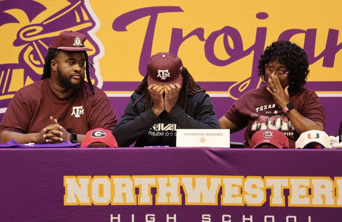 Northwestern High School football standout Tamarion Watkins, center, becomes emotional Monday, July 14, 2025 after he announced he will play football at Texas A&M University.