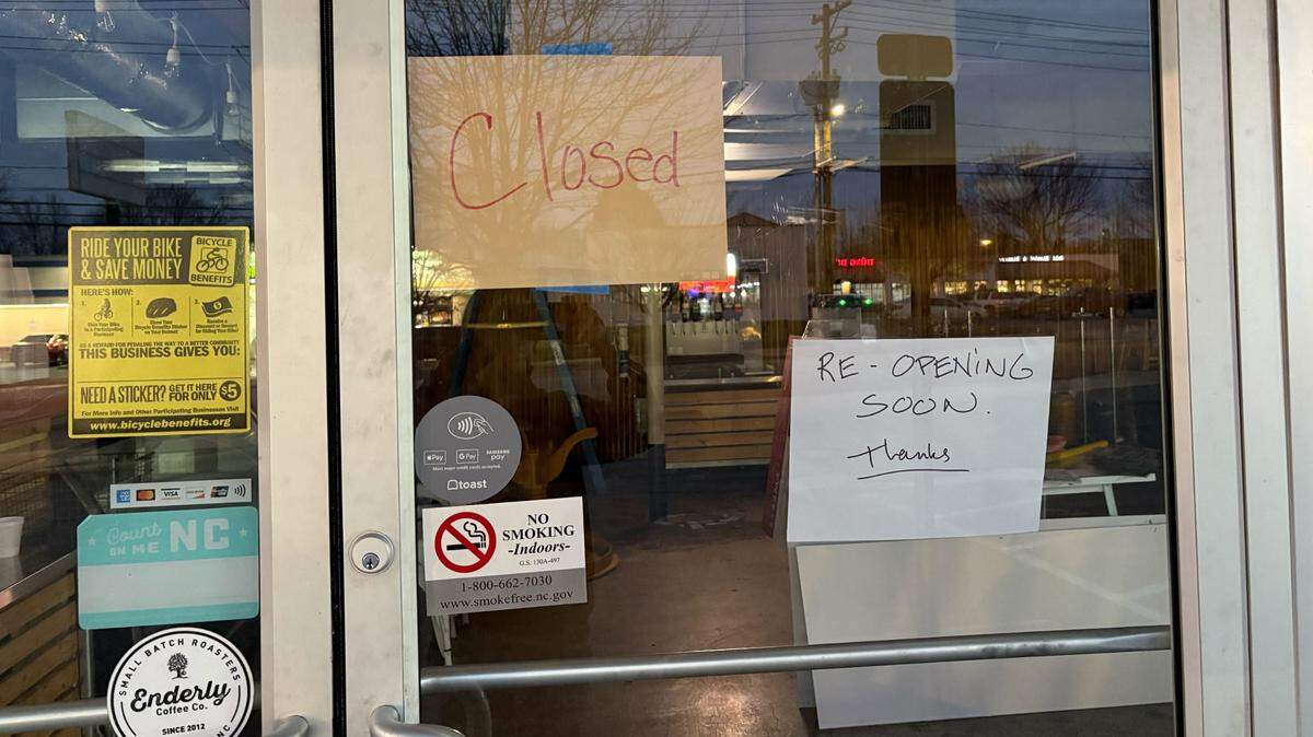 Signs on the front door at The Good Wurst Company say “Closed” and “Re-opening soon. Thanks.”