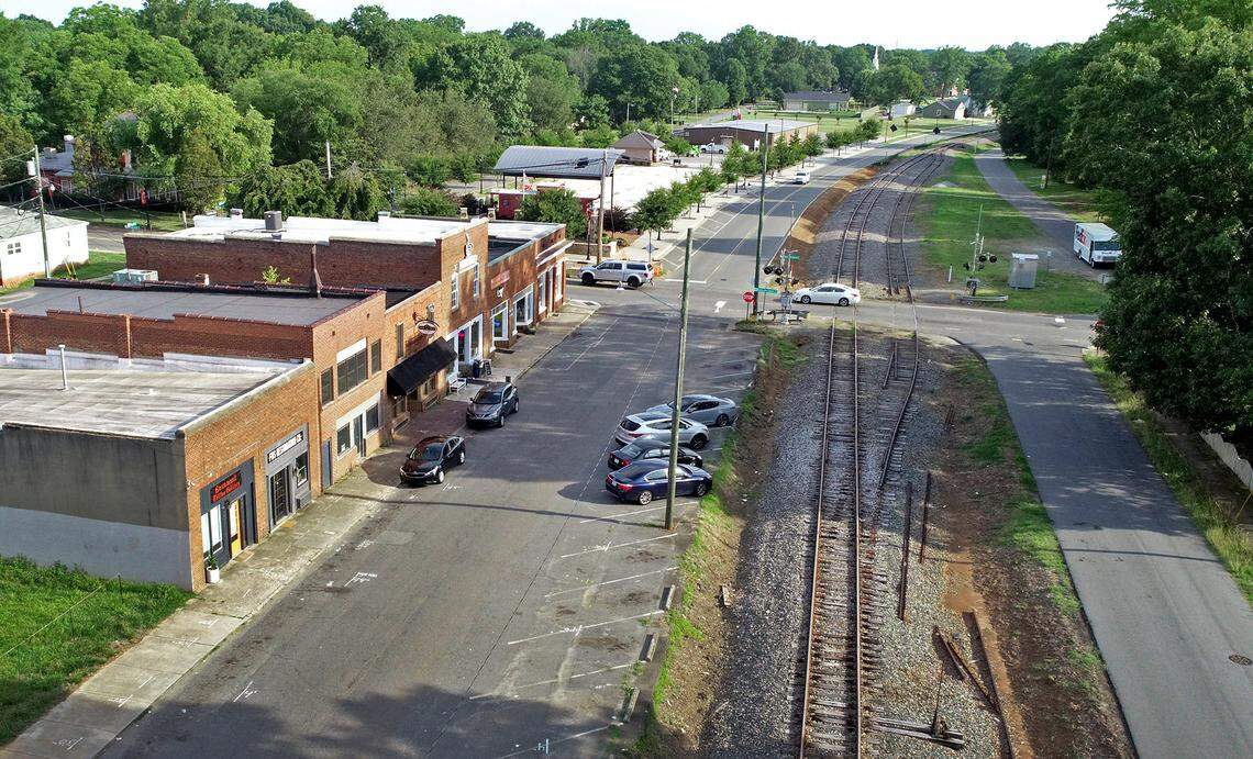 Railroad tracks owned by the Norfolk Southern Corp. travel down Main Street in Huntersville. For nearly 25 years, town residents have been promised a commuter rail connecting to center city Charlotte.