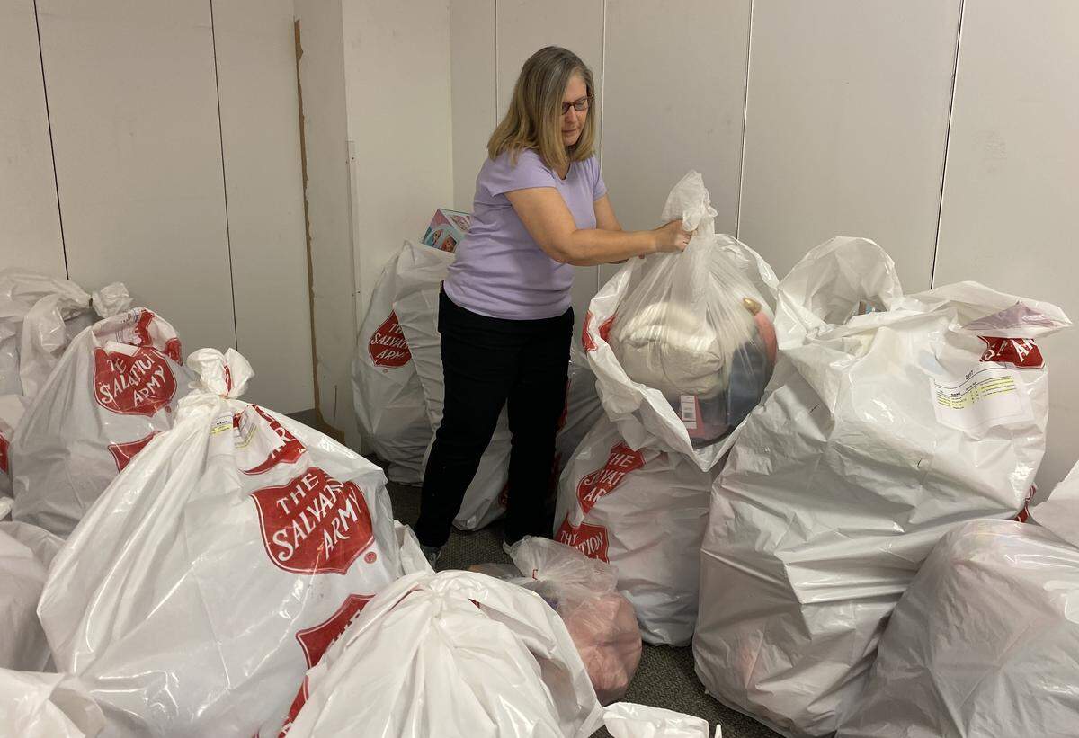 Salvation Army volunteer Terri Briggs checks bags of donated toys at the charity’s Christmas Center.