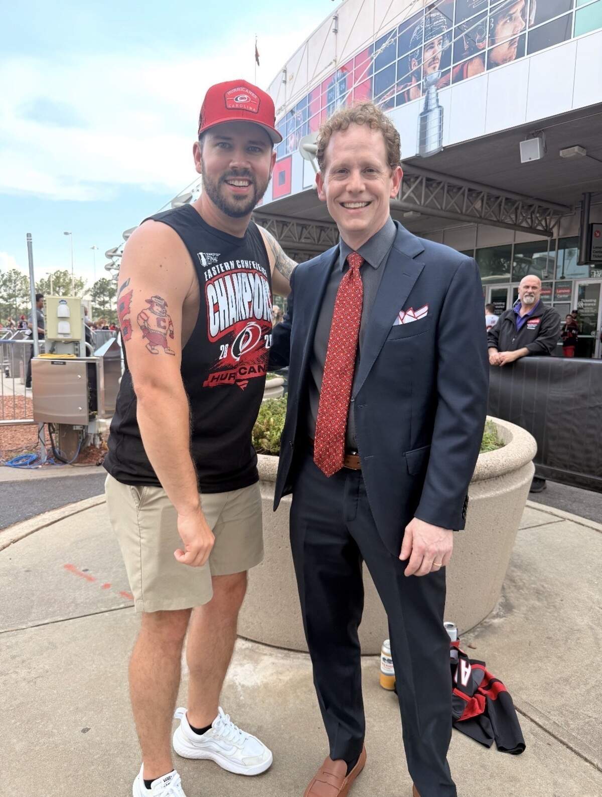 Bryson Karbley, left, and Carolina Hurricanes general manager Eric Tulsky take a photo before Game 5 of the 2026 Stanley Cup finals in front of the Lenovo Center in Raleigh.