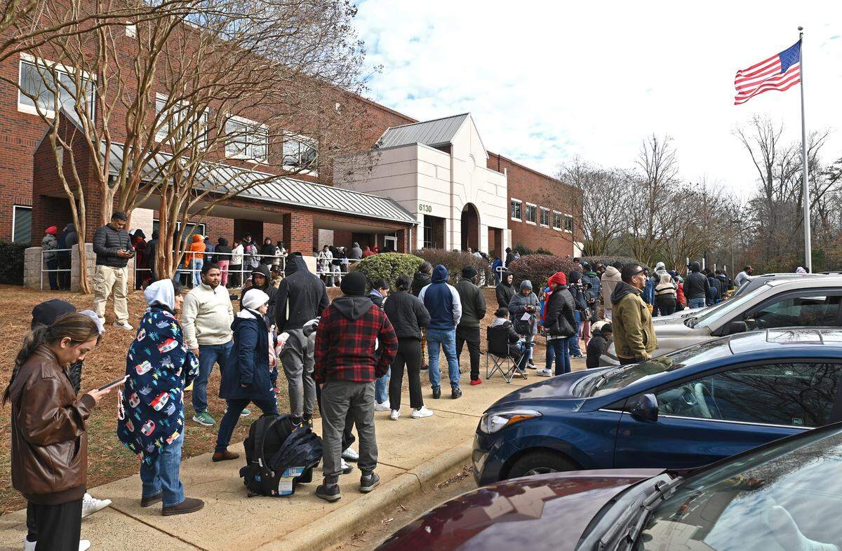 People wait outside the U.S. Department of Homeland Security office in Charlotte, NC on Thursday, January 16, 2025.