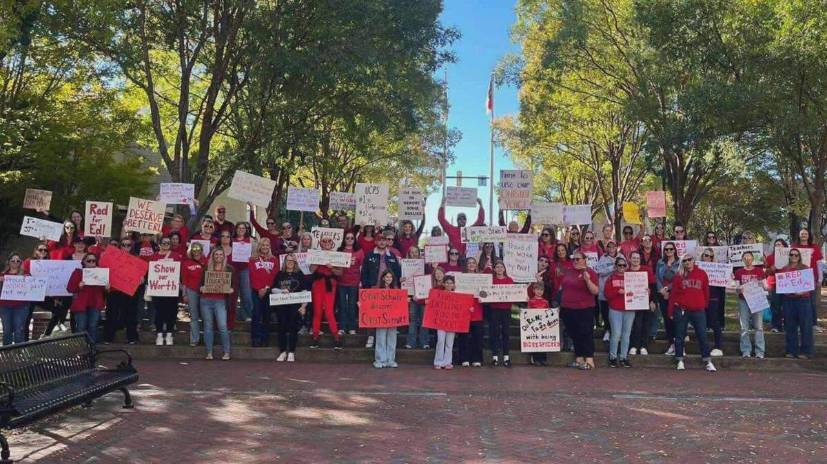 UCPS educators gather in protest outside of the district’s headquarters Wednesday. They gathered to protest the district’s choice not to pass on already approved pay raises.