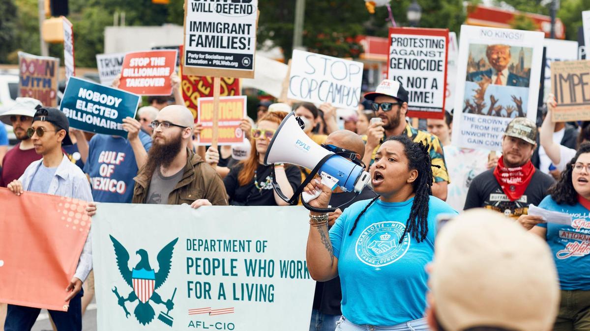 A crowd estimated at 1,500 people marched on Central Avenue Saturday for a May Day anti-Trump protest in Charlotte.