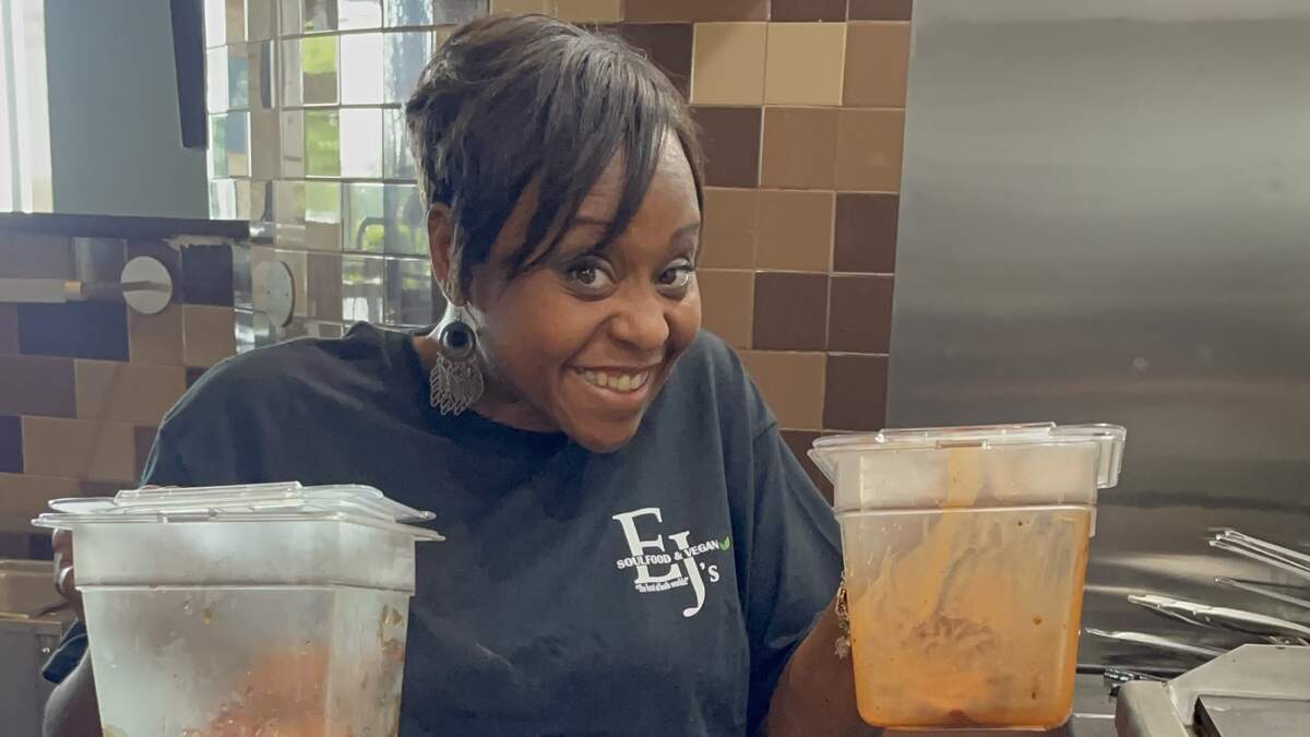 Dara J. Bess mixing fried chicken wings in her wing sauces. Courtesy of Denise, CharlotteFive.