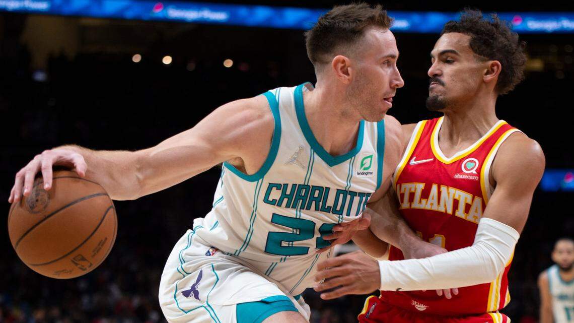 Atlanta Hawks Trae Young (11) defends Charlotte Hornets Gordon Hayward (20) during the second half of an NBA basketball game Saturday, Nov. 20, 2021, in Atlanta. (AP Photo/Hakim Wright Sr.)