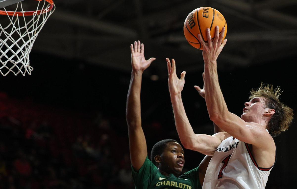 Davidson’s Reed Bailey, right, shoots over Charlotte’s Robert Braswell IV during the game at Belk Arena in Davidson Tuesday. Bailey had a team-high 18 points for Davidson.