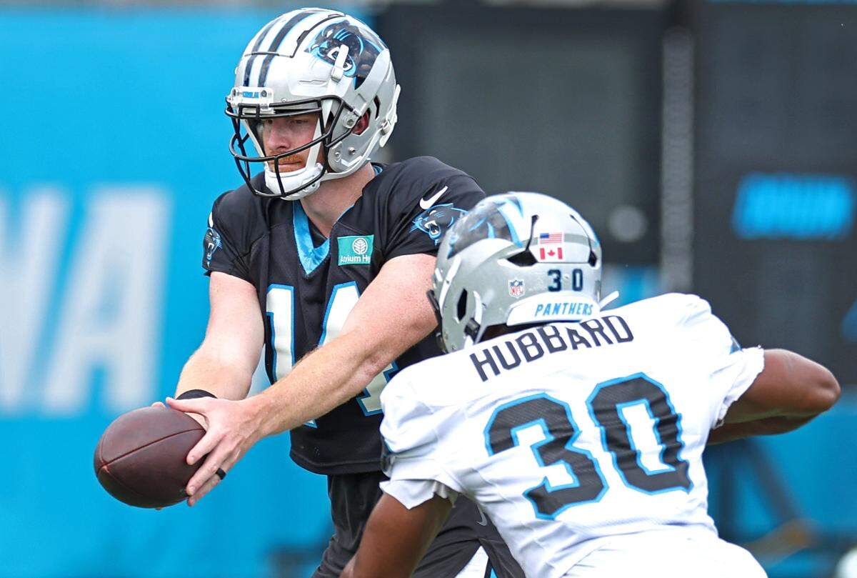 Carolina Panthers quarterback Andy Dalton, left, prepares to hand the ball to running back Chuba Hubbard, right, during practice on Wednesday, September 25, 2024.