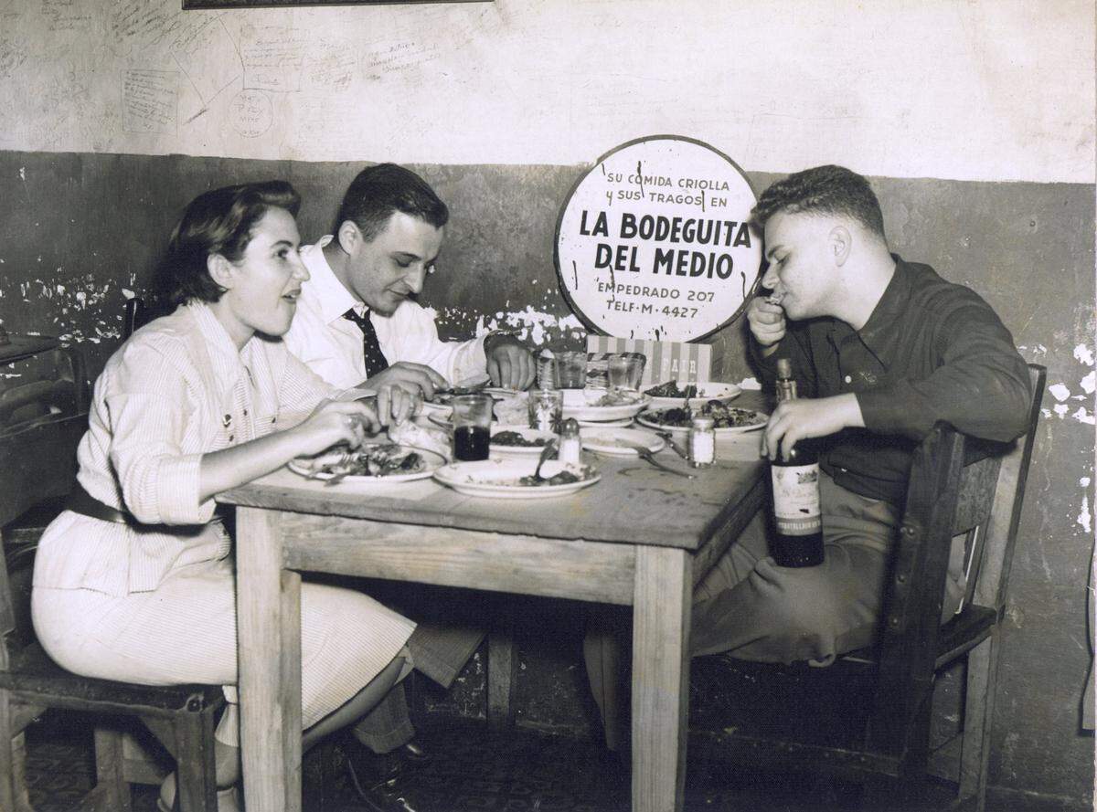In this undated photo, Sonia and Isaac Luski eat with Isaac’s cousin Gerry Grinberg in a famous Havana restaurant called “the little grocery store in the middle of the street”.
