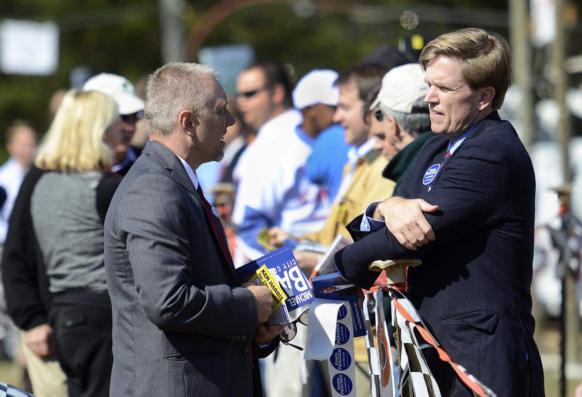 Greg Amick, left, talks with Edwin Peacock, a Republican candidate for Charlotte mayor at the Mallard Creek BBQ on Thursday Oct. 24, 2013.  
