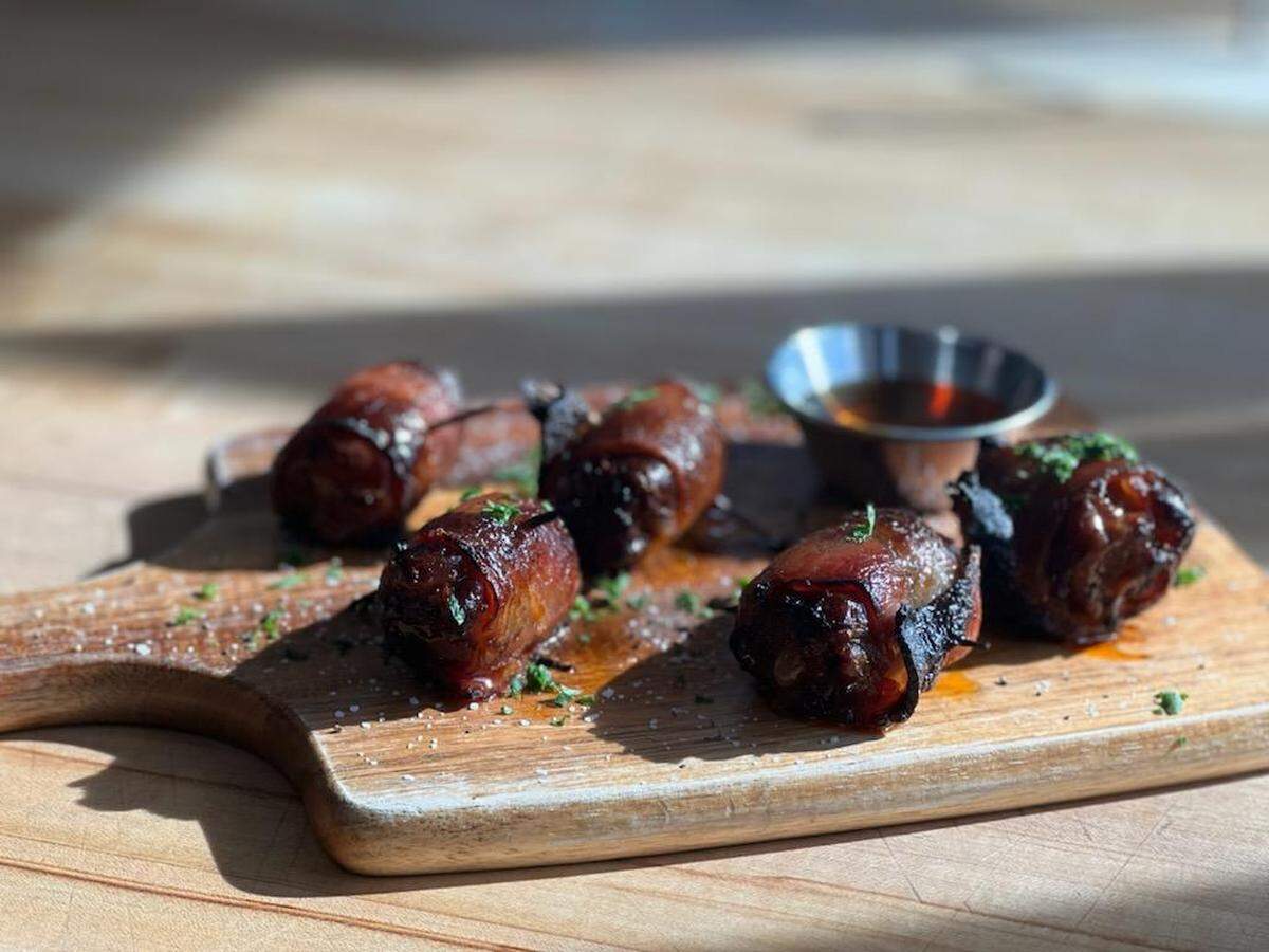 The Devils on Horseback — bacon-wrapped dates stuffed with chorizo and manchego — is the most popular menu item at The Loyalist Market.