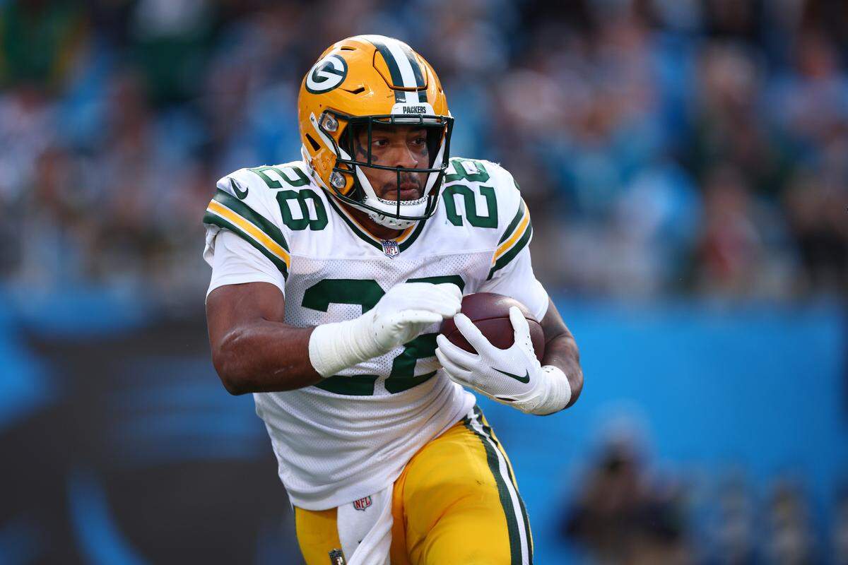 AJ Dillon carries the ball for the Packers during a game against the Carolina Panthers at Bank of America Stadium on Dec. 24, 2023 in Charlotte.