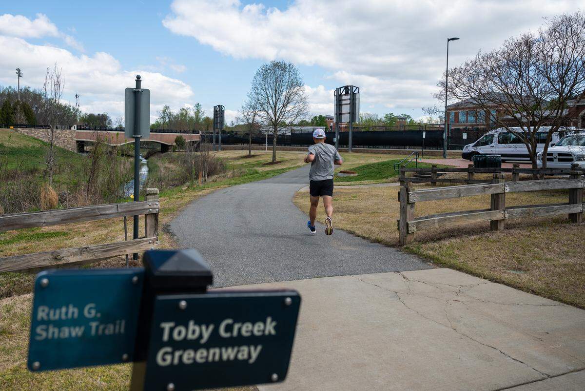 The part of the greenway that runs through UNC Charlotte's campus slices between a variety of athletic complexes, including the collection of tennis courts off to the right in this photo.