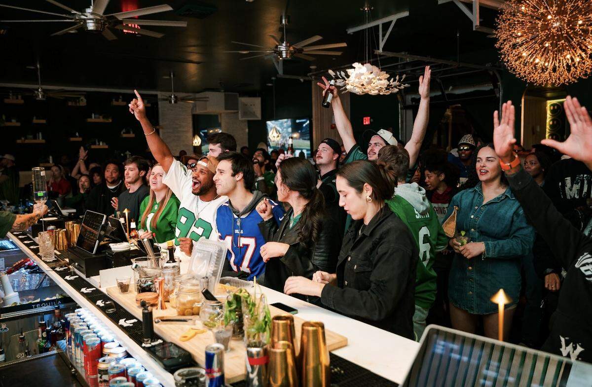 Crowds gather at Must Be Nice to cheer on the Philadelphia Eagles.