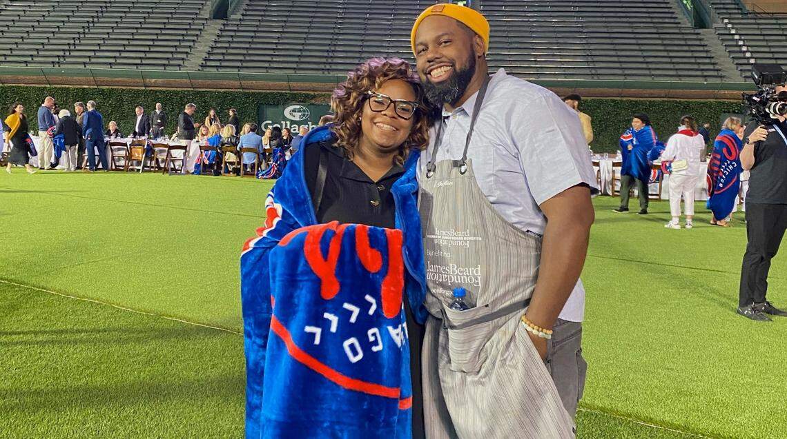 BayHaven Restaurant Group founders Subrina Collier and chef Gregory Collier stand in the outfield of Wrigley Field after the inaugural Friends of James Beard Benefits Stadium Chef Series in 2022.