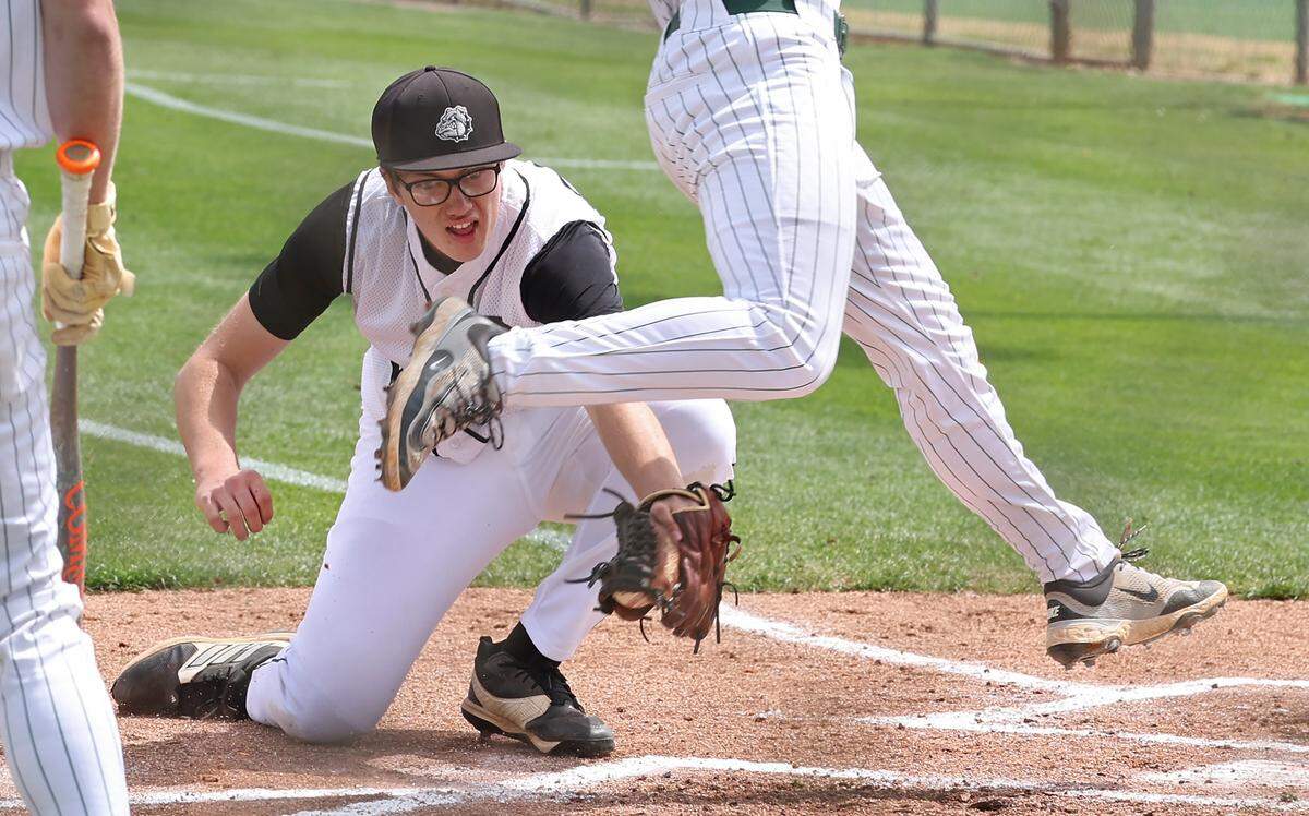 Butler Bulldogs pitcher Patrick O’Shaughnessy, left, is unable to put the tag on Charlotte Country Day’s Mac Summerville as he leaps toward home plate during the Jack Sink Classic at Charlotte Country Day School on Monday, April 6, 2026. Country Day defeated Butler 3-2.