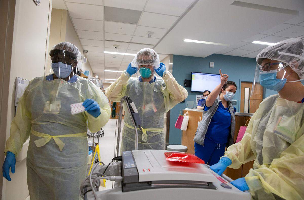 Staff in the Emergency Department at Duke Regional Hospital in Durham, NC get ready to check on a COVID-19 patient. 