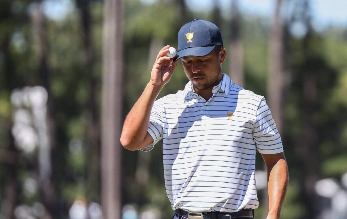 Xander Schauffele taps his ball to the brim of his hat during the second round of the Presidents Cup at Quail Hollow Golf Club in Charlotte, N.C., on Friday, September 23, 2022.