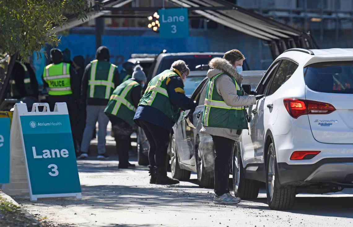 Motorist are processed in line as part of the Atrium Health vaccine clinic hosted at Bank of America Stadium on Friday, January 29, 2021. Atrium Health, Honeywell, Tepper Sports & Entertainment and Charlotte Motor Speedway formed a public-private partnership that expects to vaccinate 19,000 people at the Friday through Sunday event.