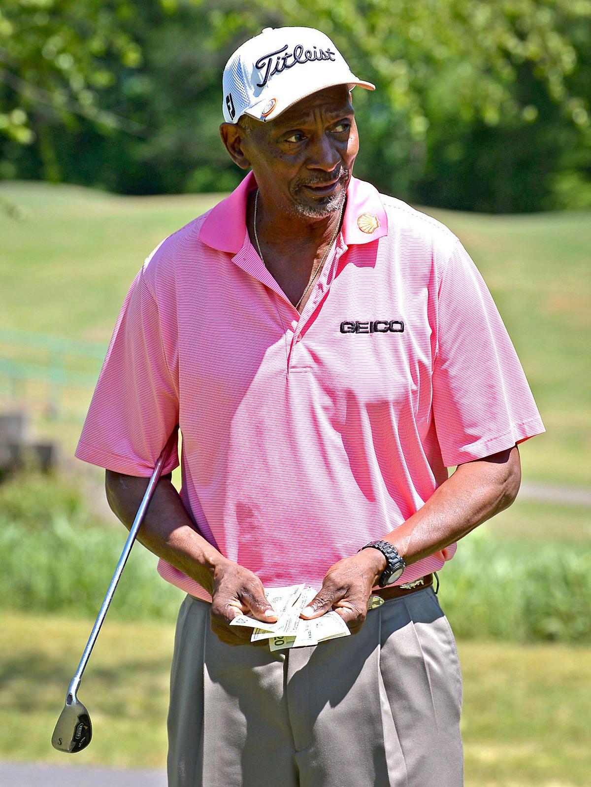 James “Slim” Bouler flashes the money from his pocket on Thursday, May 7, 2020 at the Dr. Charles L. Sifford Golf Course in Charlotte, NC. Bouler beat NBA star Michael Jordan out of $57,000 in one three-day weekend of golf in 1991. Bouler would later go to trial in a federal court where Jordan would appear as a witness in 1992.