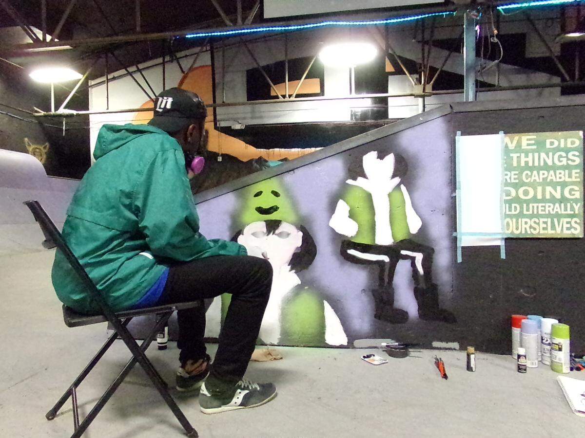 Charlotte artist Francesko Art works on a mural at Oso Skate Park. “My style of art can be described as abstract and original,” he said. “My favorite mediums are acrylics and watercolors. I create cartoons, comics and caricatures.”