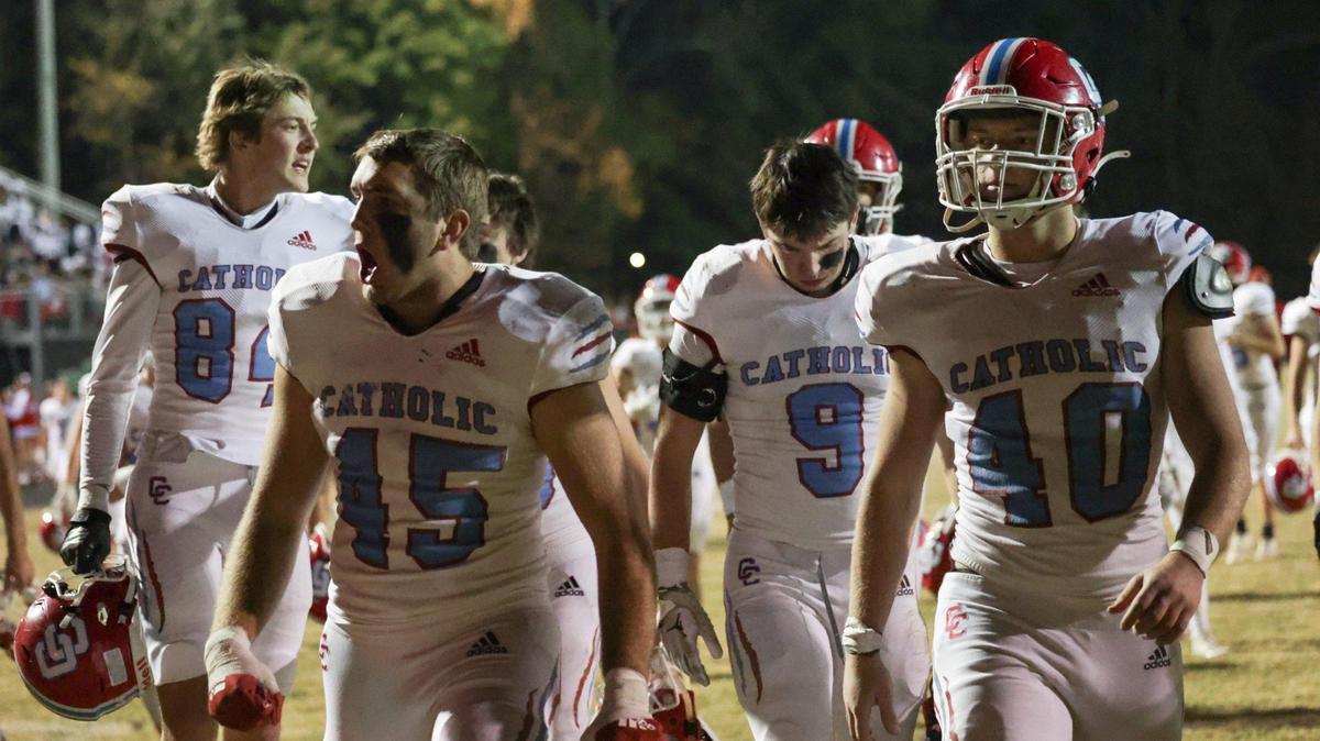 Charlotte Catholic players yell out in celebration after the end of the first half, during which they took a 28-9 lead over Myers Park during the first round of the NCHSAA playoffs on Friday, November 3, 2023.
