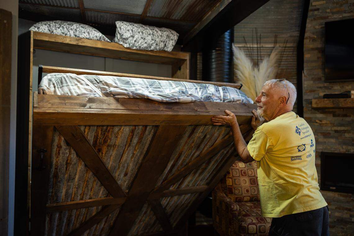Tom Flohr closes a handmade Murphy bed in the silos that he and his wife, Betty, converted into an short-term rental in Lincolnton, N.C., shown on Friday, April 3, 2026.